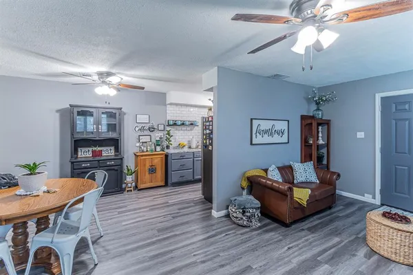 a living room with furniture and a wooden floor