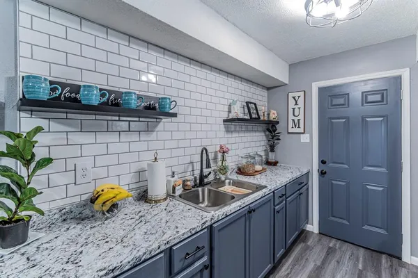 a kitchen with a sink a counter and cabinets