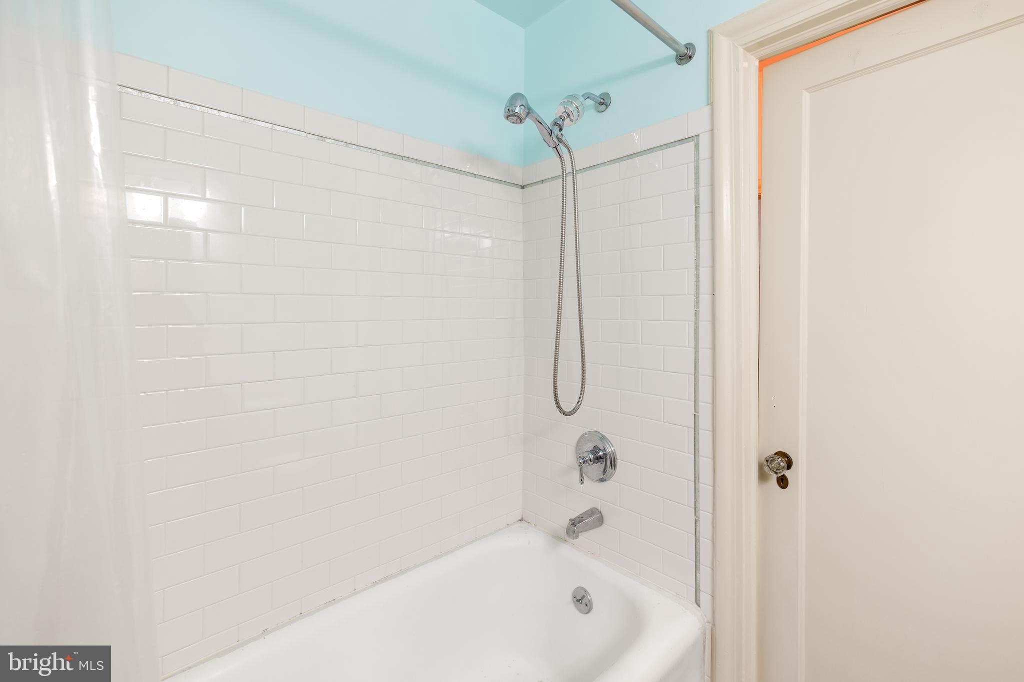2032 Belmont Road Northwest, Unit 302 Washington, DC 20009 - Photo 27 of 31 Renovated Tile Surrounding Tub and Shower