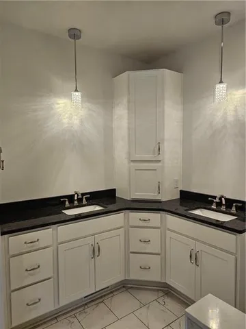 a kitchen with white cabinets and a sink