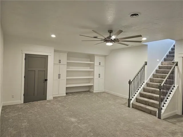 a view of an empty room with a ceiling fan
