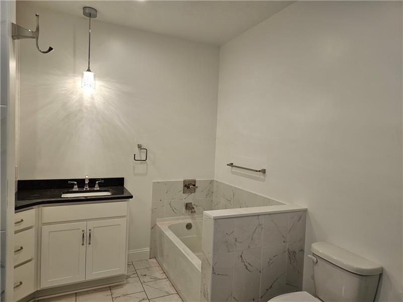 801 Wimbledon Drive Mount Pleasant, PA 15666 - Photo 10 of 18 a bathroom with a bathtub and a sink