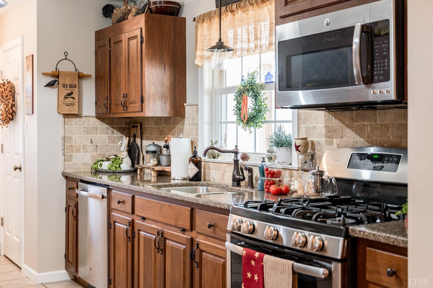 375 East Perch Road Monroe, VA 24574 - Photo 12 of 73 a kitchen with stainless steel appliances granite countertop a stove and a microwave