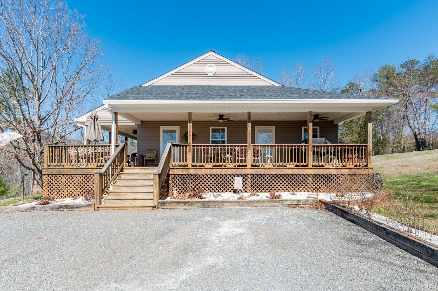 375 East Perch Road Monroe, VA 24574 - Photo 38 of 73 a front view of a house with basket ball court and wooden fence