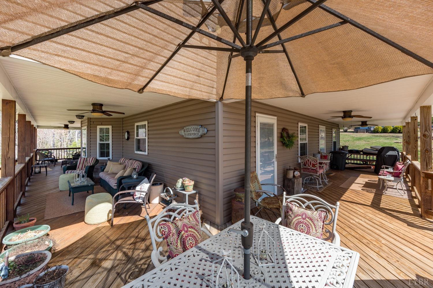 375 East Perch Road Monroe, VA 24574 - Photo 44 of 73 a view of a patio with table and chairs and potted plants