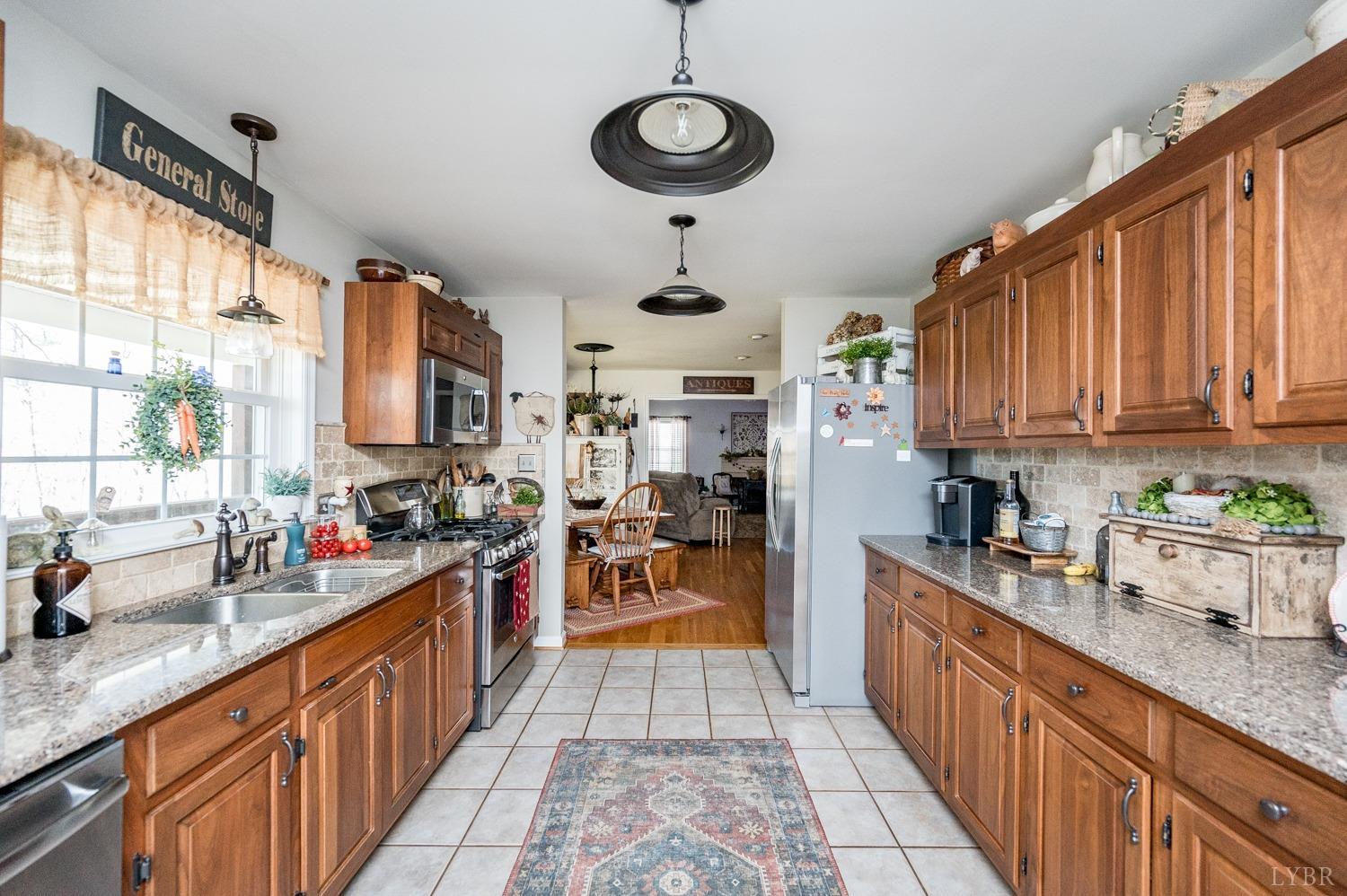 375 East Perch Road Monroe, VA 24574 - Photo 8 of 73 a kitchen with stainless steel appliances granite countertop a sink stove top oven and cabinets