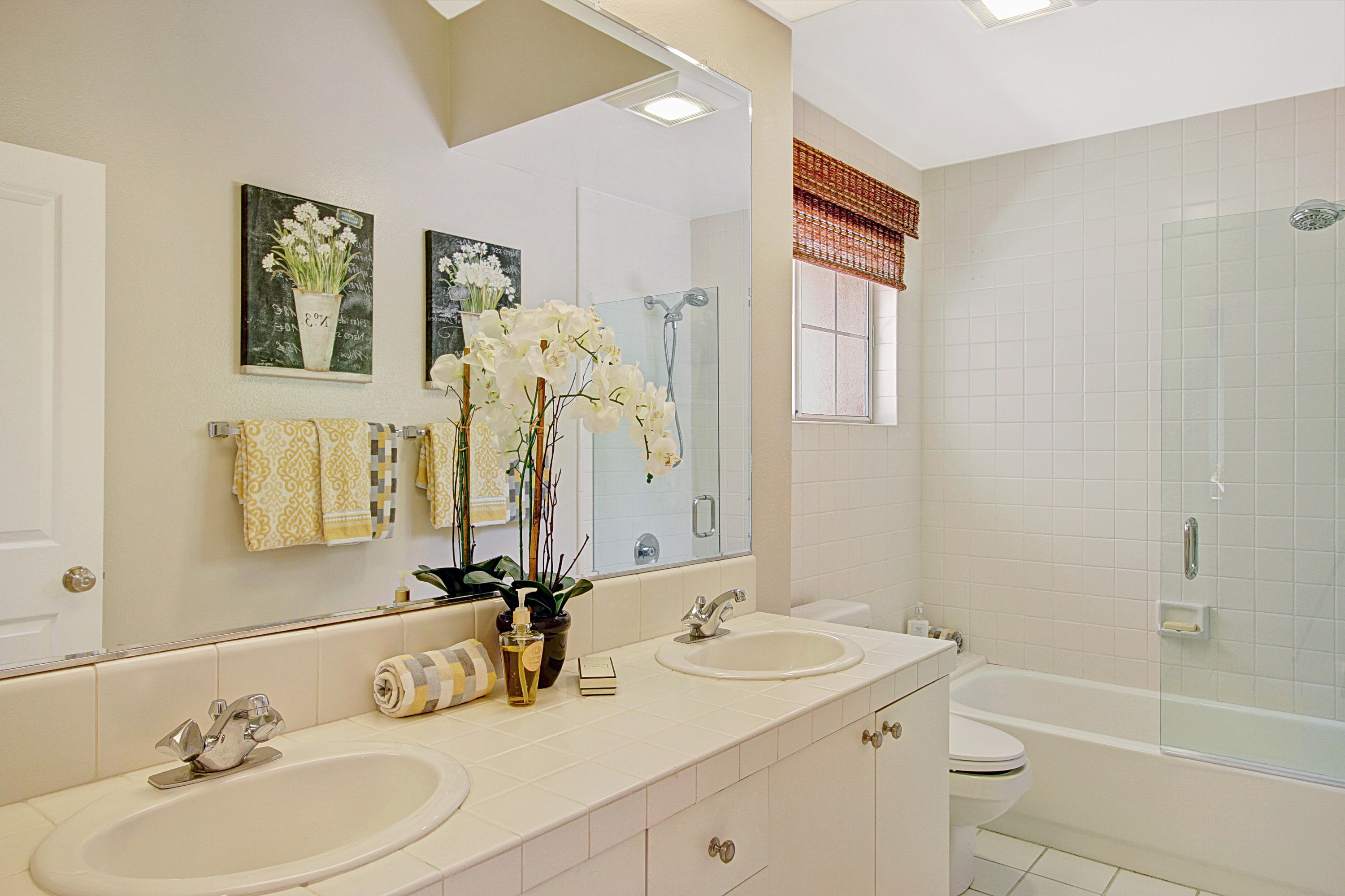4008 Primavera Road Santa Barbara, CA 93110 - Photo 11 of 21 a bathroom with a double vanity sink mirror and toilet