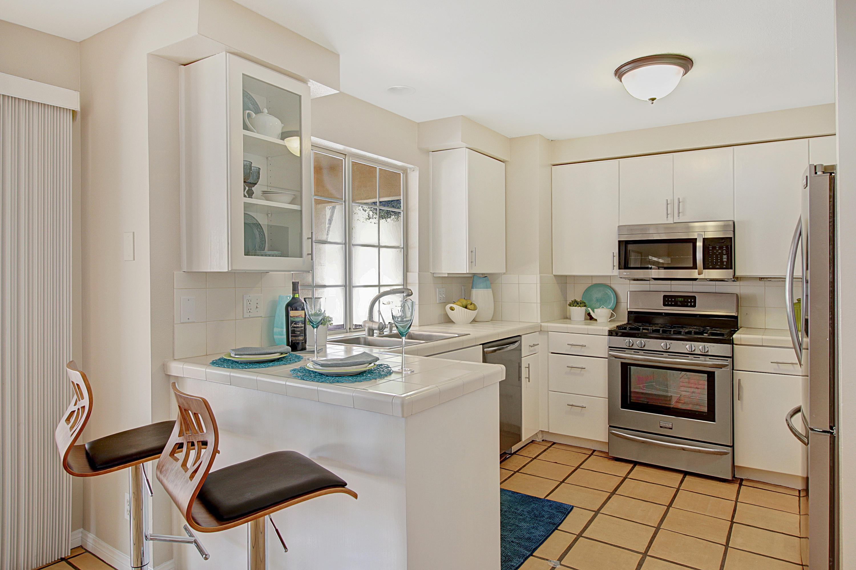 4008 Primavera Road Santa Barbara, CA 93110 - Photo 21 of 21 a kitchen with stainless steel appliances granite countertop a stove a sink a microwave and a refrigerator