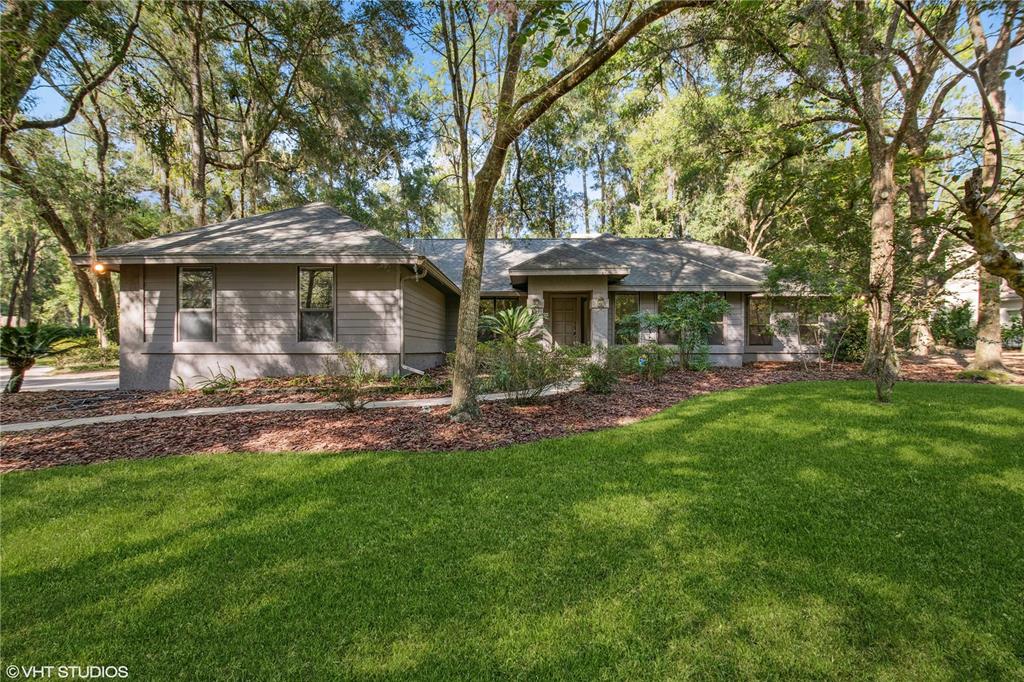 4309 Southwest 86 Way Gainesville, FL 32608 - Photo 1 of 1 a view of a house with a yard potted plants and large tree