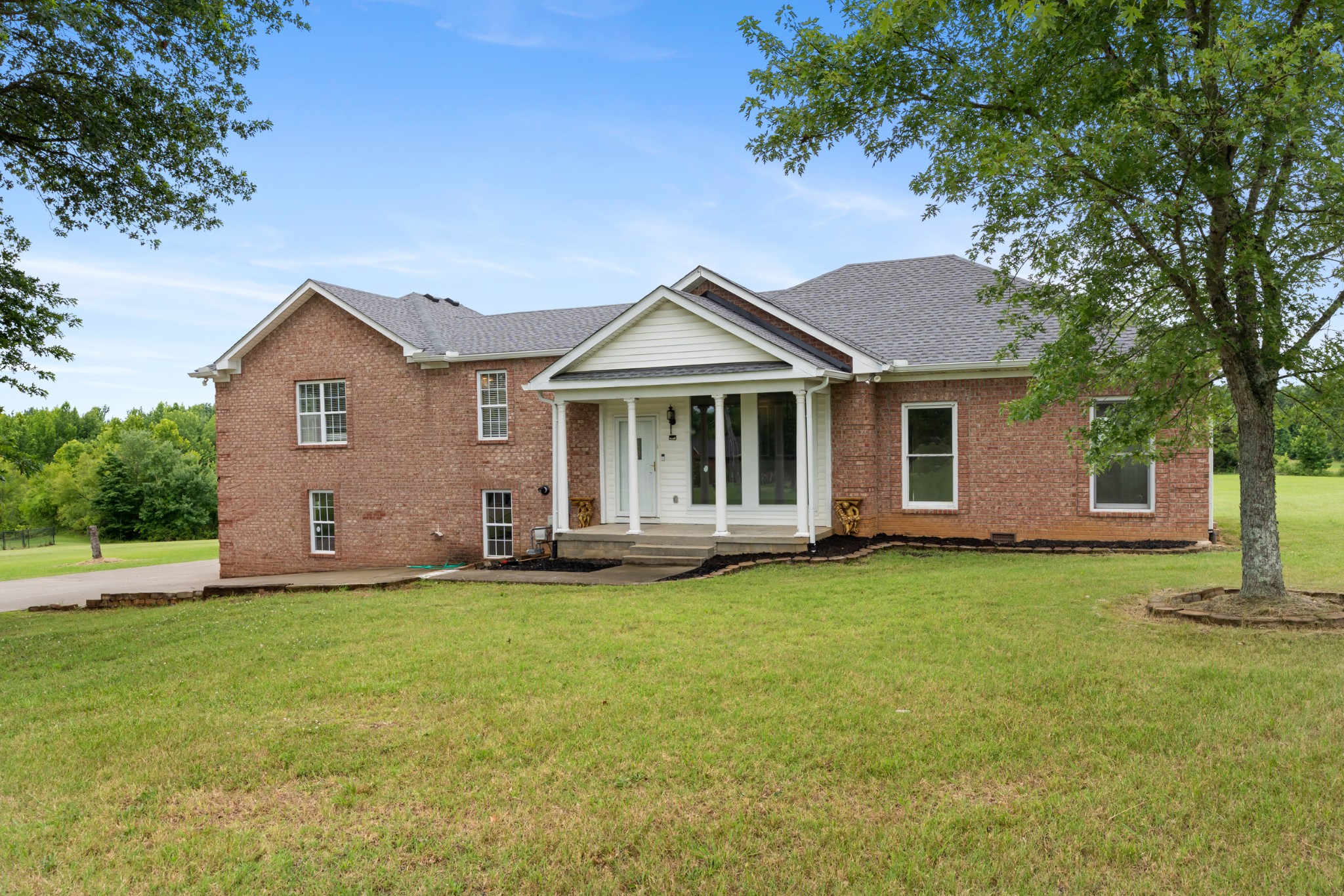 4602 Washington Road Springfield, TN 37172 - Photo 2 of 63 a front view of a house with a garden and trees