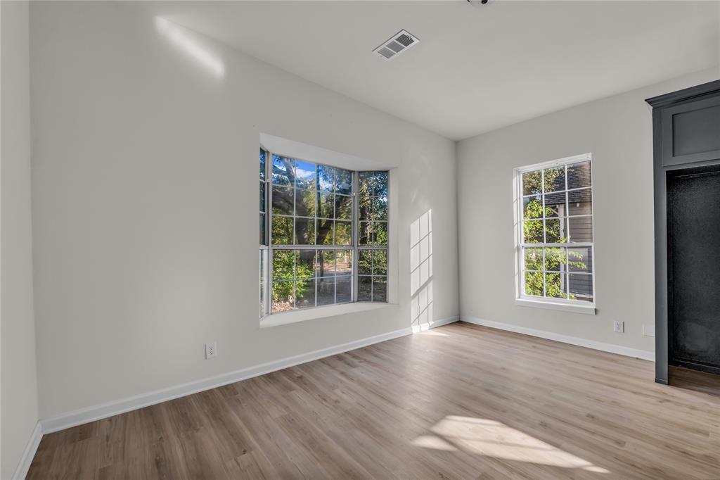 2524 McFerrin Avenue Waco, TX 76708 - Photo 13 of 29 an empty room with wooden floor and windows