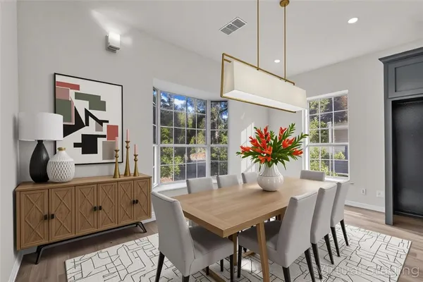 a view of a dining room with furniture window and wooden floor