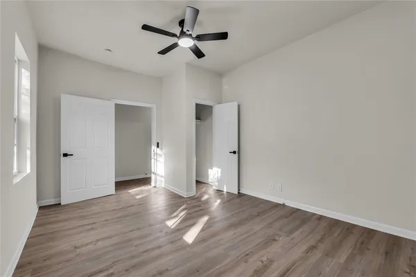 a view of an empty room and wooden floor