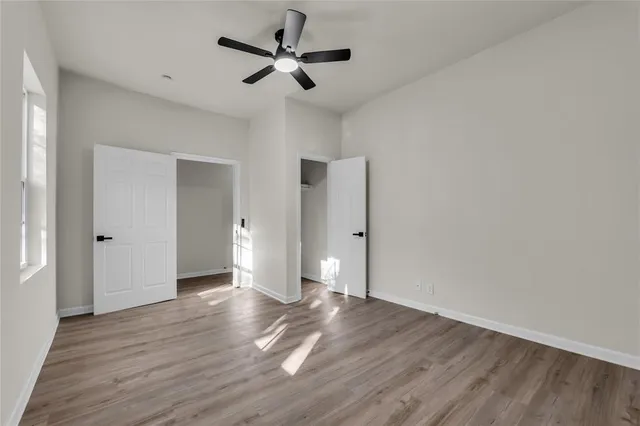 a view of an empty room and wooden floor