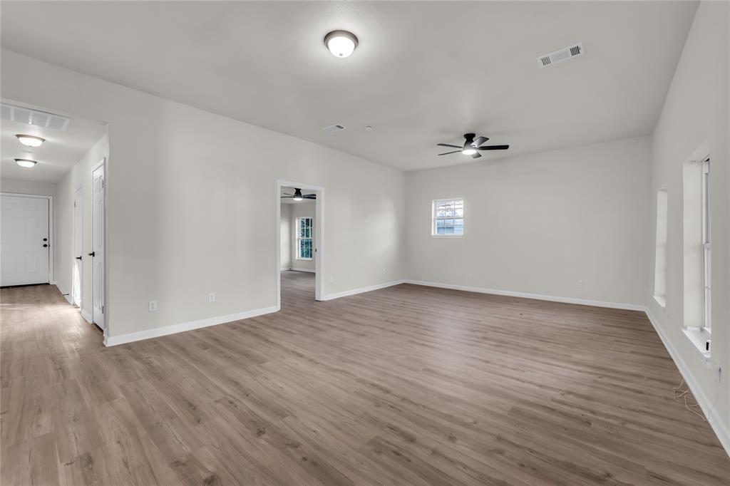 2524 McFerrin Avenue Waco, TX 76708 - Photo 5 of 29 an empty room with wooden floor and windows