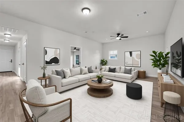 a living room with furniture and a large mirror