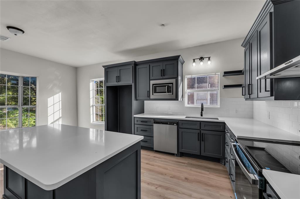 2524 McFerrin Avenue Waco, TX 76708 - Photo 9 of 29 a kitchen with stainless steel appliances granite countertop a sink counter space and cabinets