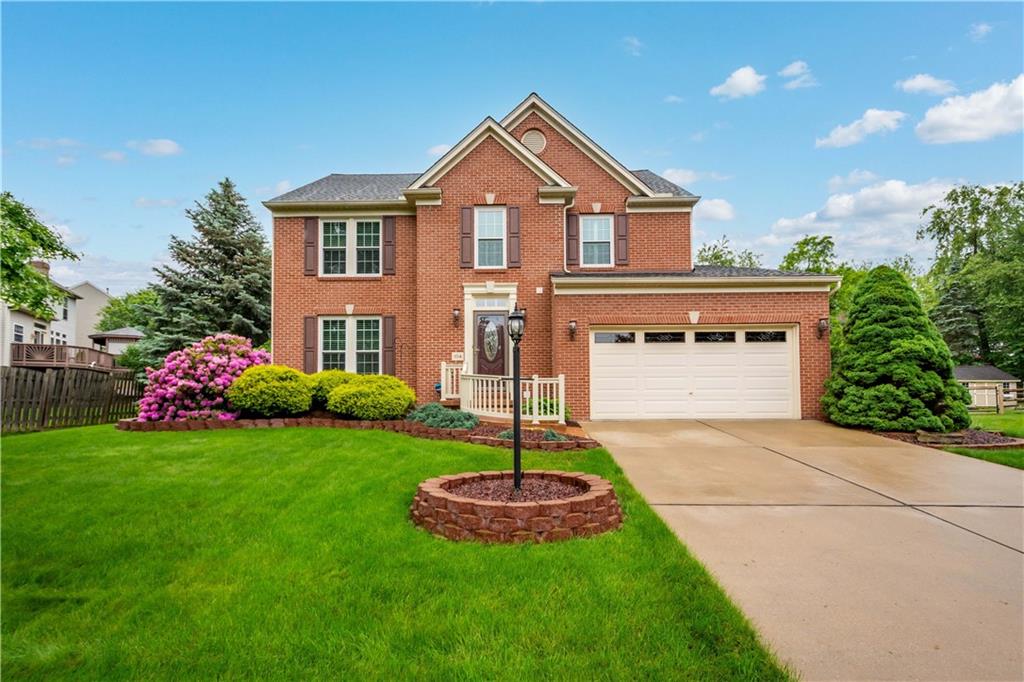 a front view of a house with a yard and garage