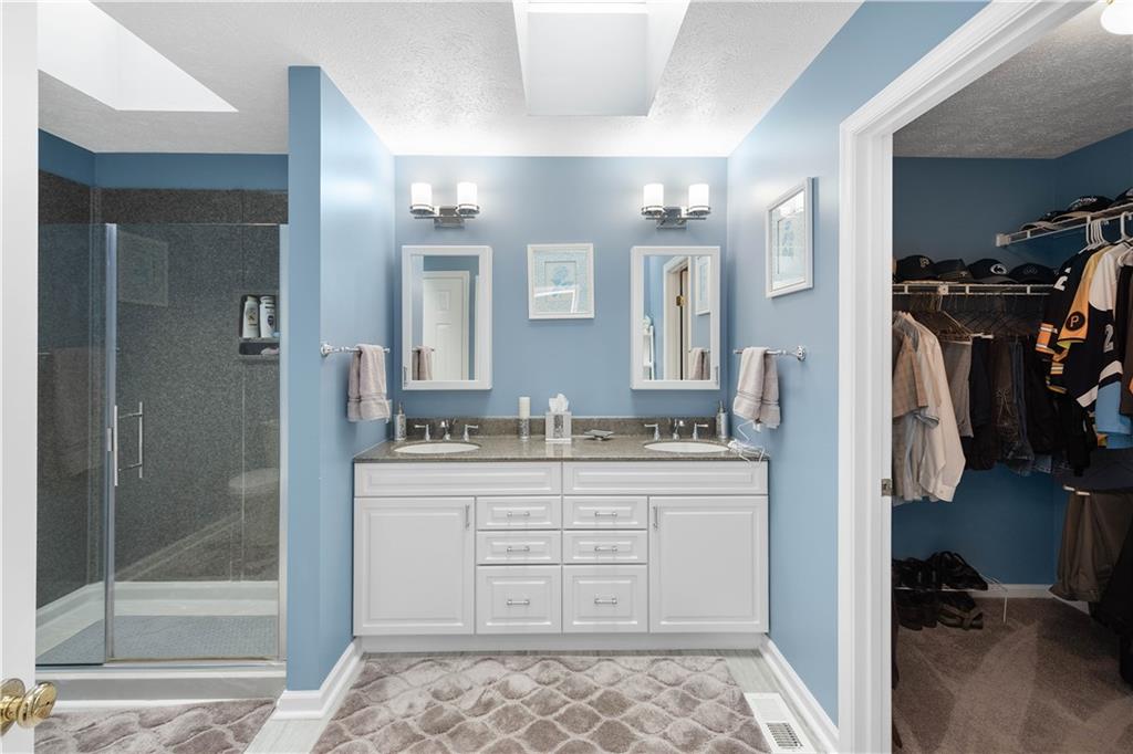 104 Camelot Circle Coraopolis, PA 15108 - Photo 21 of 33 a bathroom with a sink a mirror and a shower