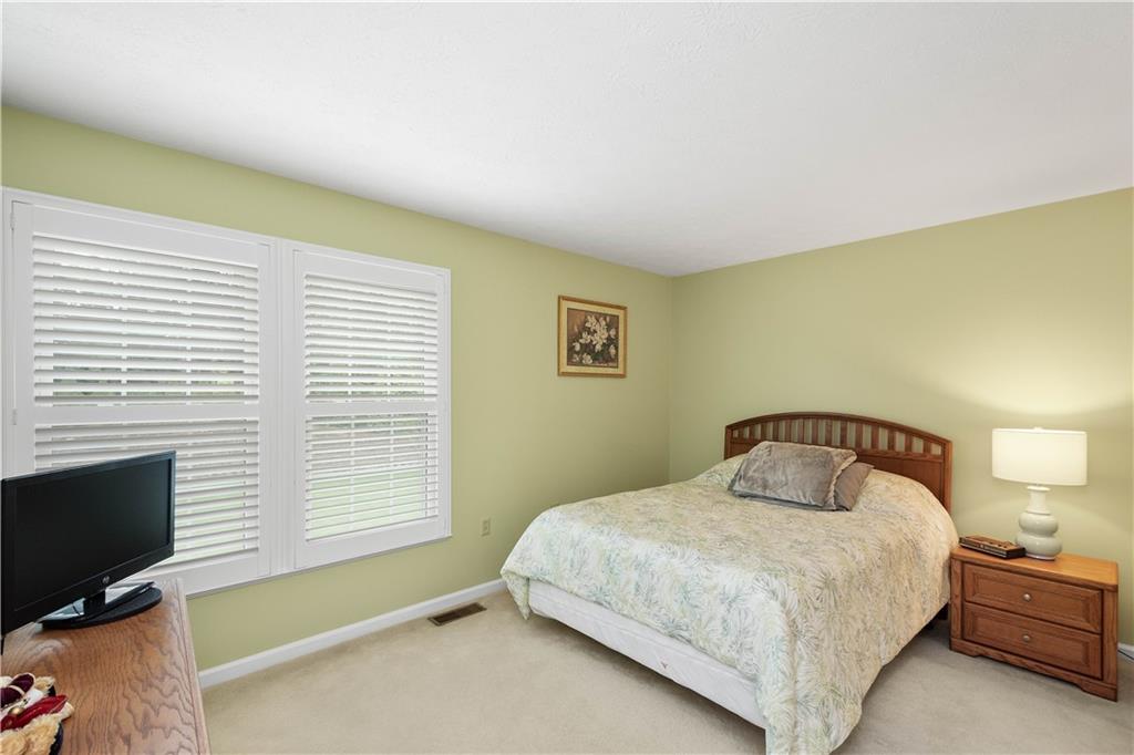104 Camelot Circle Coraopolis, PA 15108 - Photo 24 of 33 a bedroom with a bed flat screen tv and windows