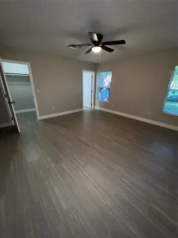 a view of a room with wooden floor