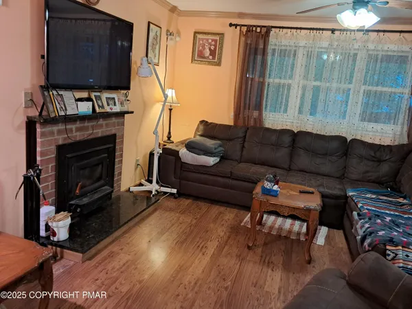 a living room with furniture a fireplace and a flat screen tv