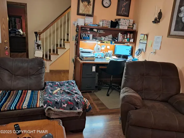 a living room with furniture and a floor to ceiling window