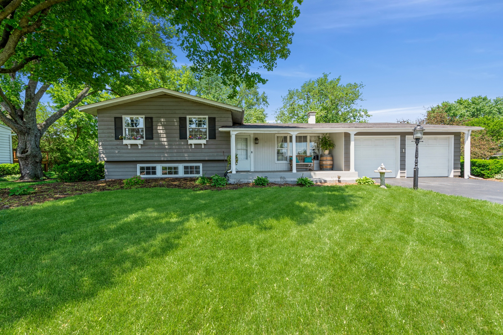 426 High Road Cary, IL 60013 - Photo 1 of 28 a front view of a house with a yard and trees