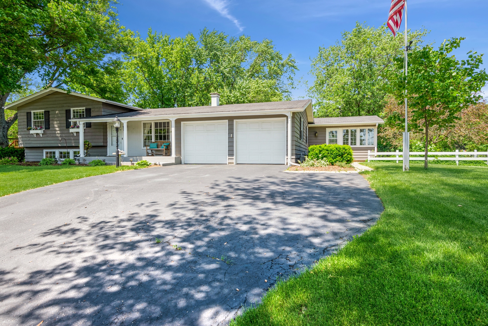 426 High Road Cary, IL 60013 - Photo 2 of 28 a front view of a house with a yard and trees
