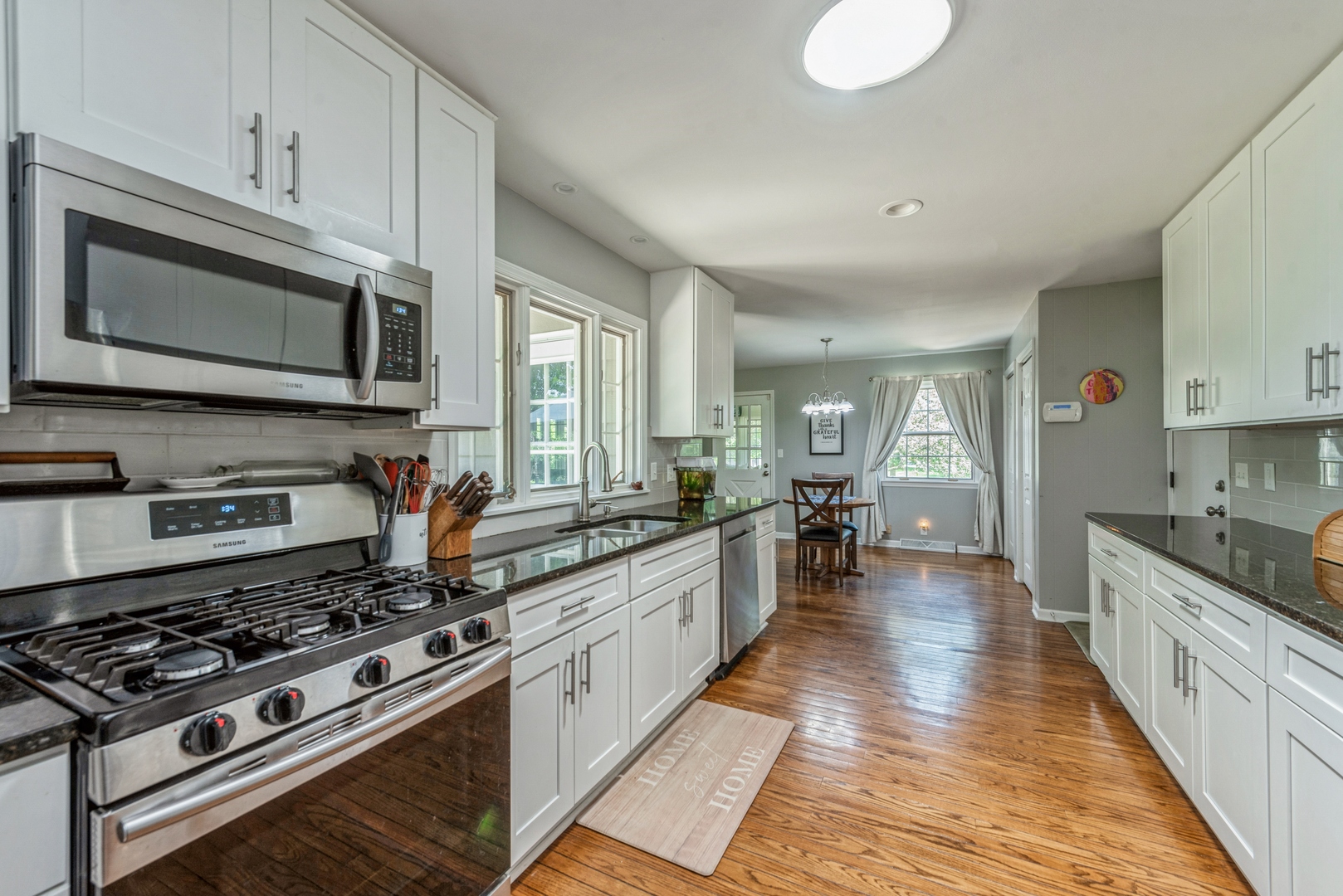 426 High Road Cary, IL 60013 - Photo 8 of 28 a large kitchen with stainless steel appliances granite countertop a stove and a sink