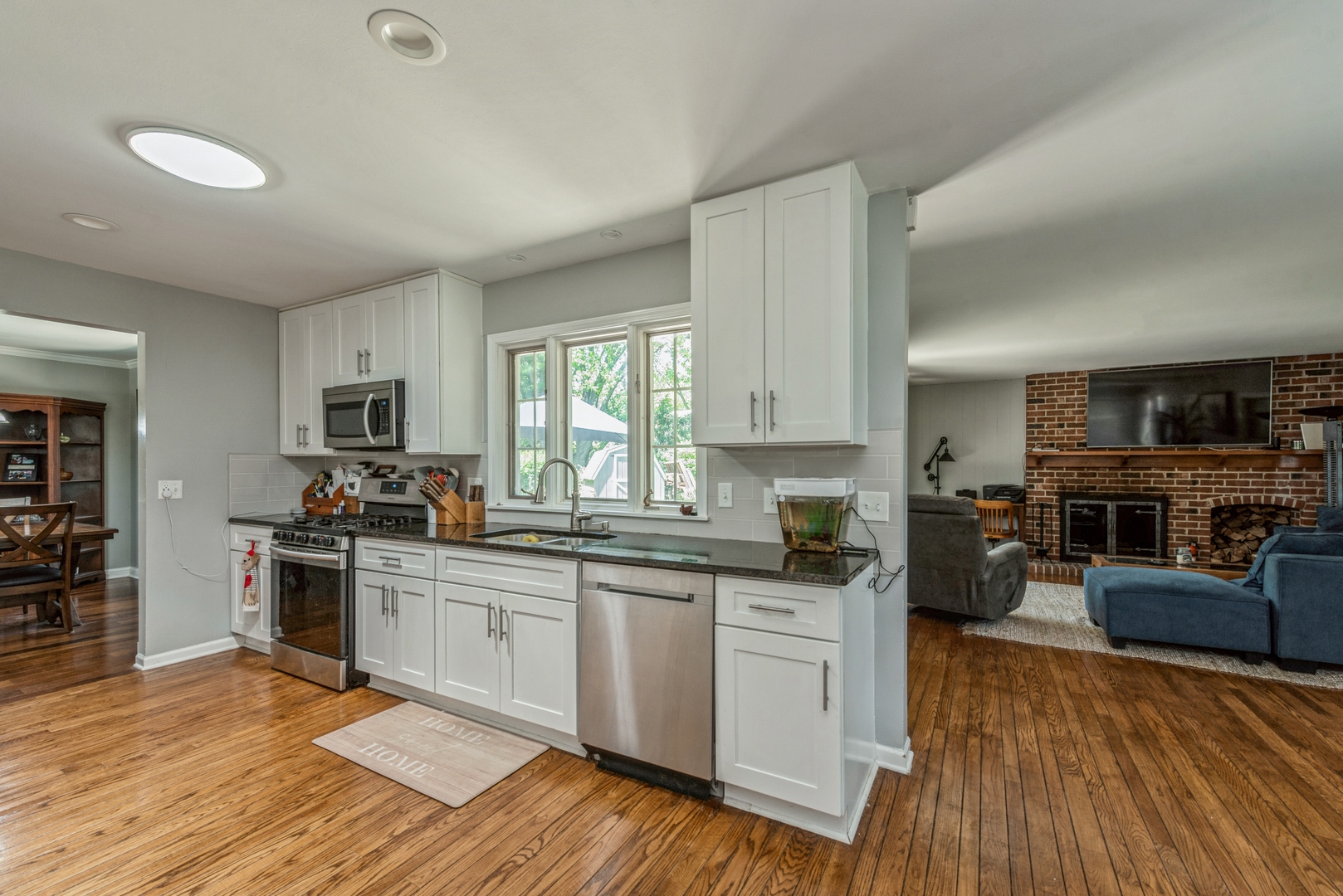 426 High Road Cary, IL 60013 - Photo 9 of 28 a kitchen with stainless steel appliances granite countertop wooden cabinets a sink dishwasher a stove and a refrigerator with wooden floor