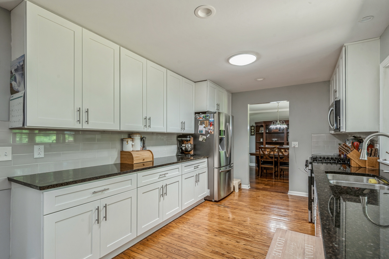 426 High Road Cary, IL 60013 - Photo 10 of 28 a kitchen with stainless steel appliances granite countertop a sink stove and refrigerator