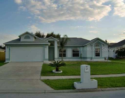 424 Bramble Way Minneola, FL 34715 - Photo 1 of 1 a front view of a house with a garden and yard