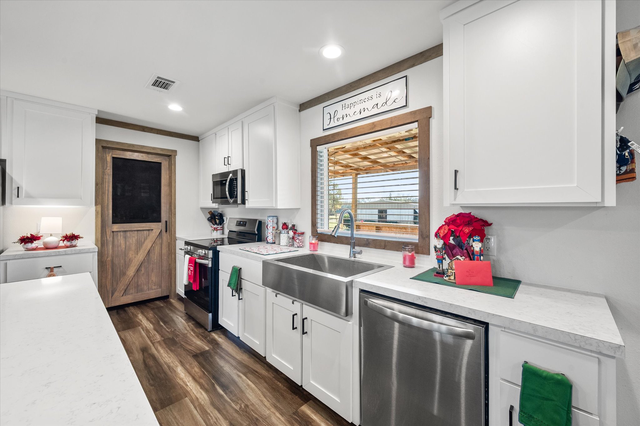 16857 Fm 639 Road East Purdon, TX 76679 - Photo 22 of 38 Kitchen featuring white cabinets, stainless steel appliances, light countertops, dark wood-type flooring, and recessed lighting