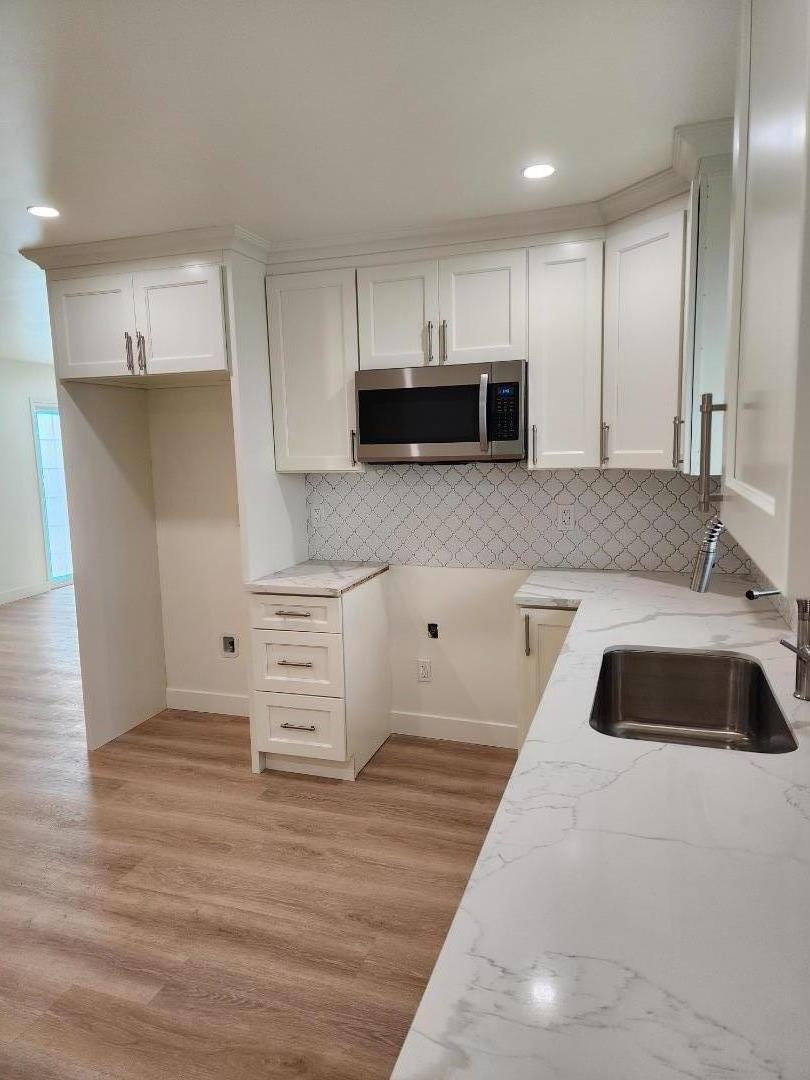 3280 Cheyenne Drive Merced, CA 95348 - Photo 11 of 34 a kitchen with stainless steel appliances kitchen island granite countertop a stove a sink and a microwave