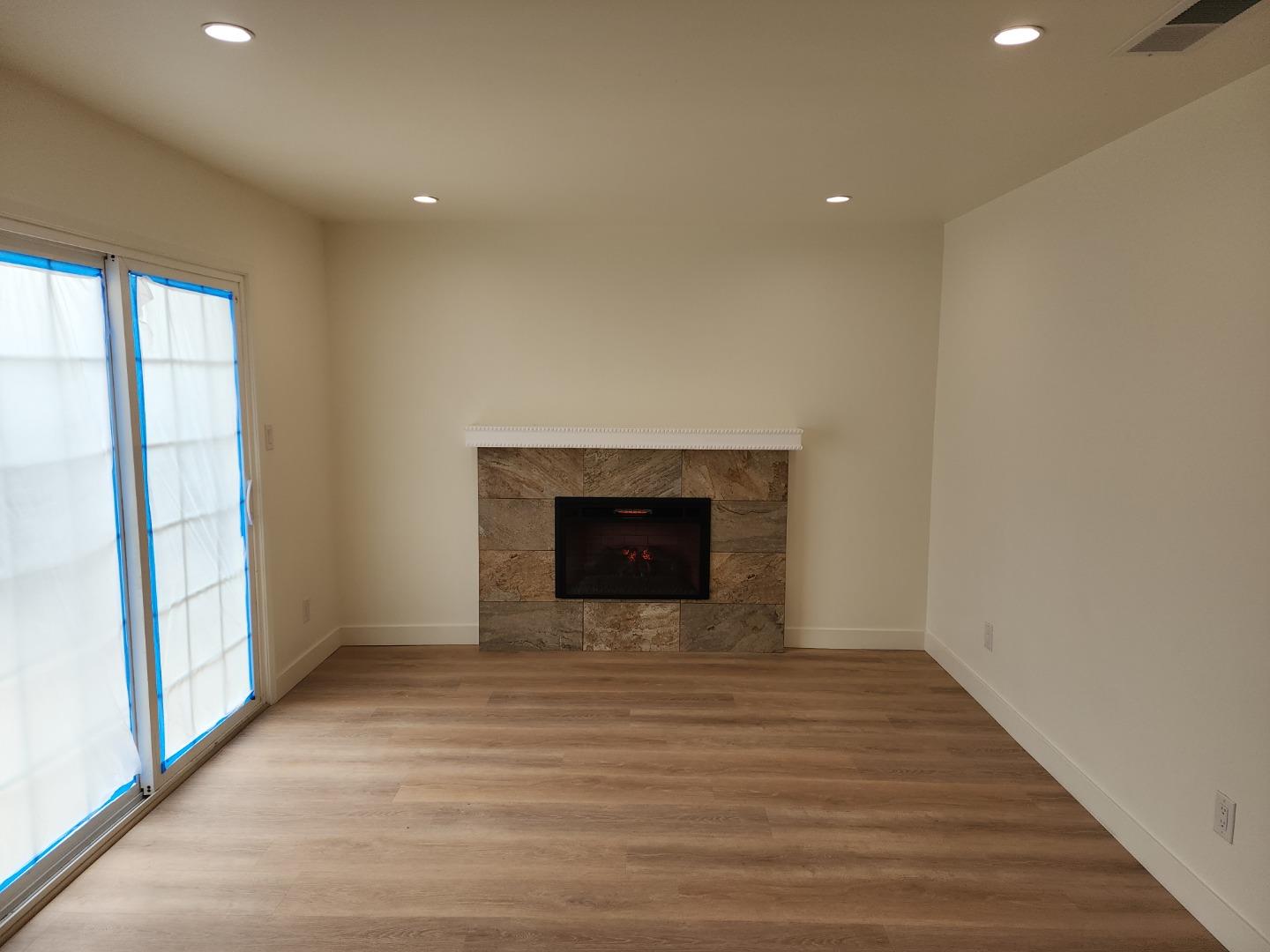 3280 Cheyenne Drive Merced, CA 95348 - Photo 17 of 34 a view of an empty room with a fireplace and a window