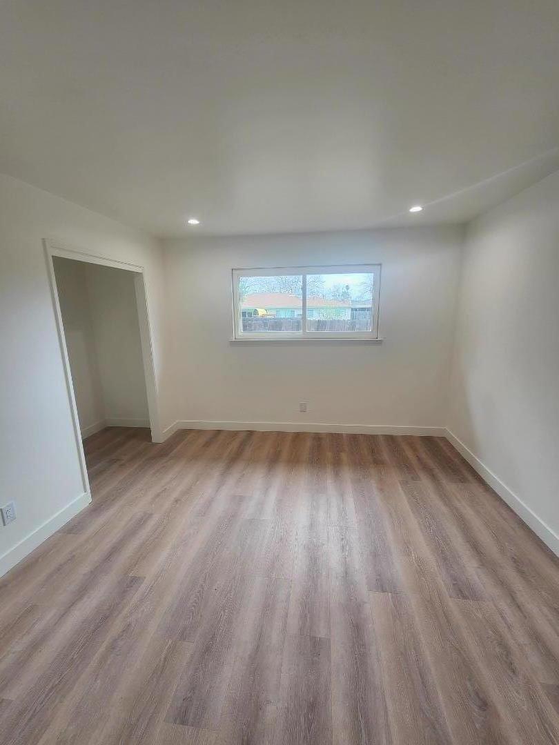 3280 Cheyenne Drive Merced, CA 95348 - Photo 26 of 34 an empty room with wooden floor and windows