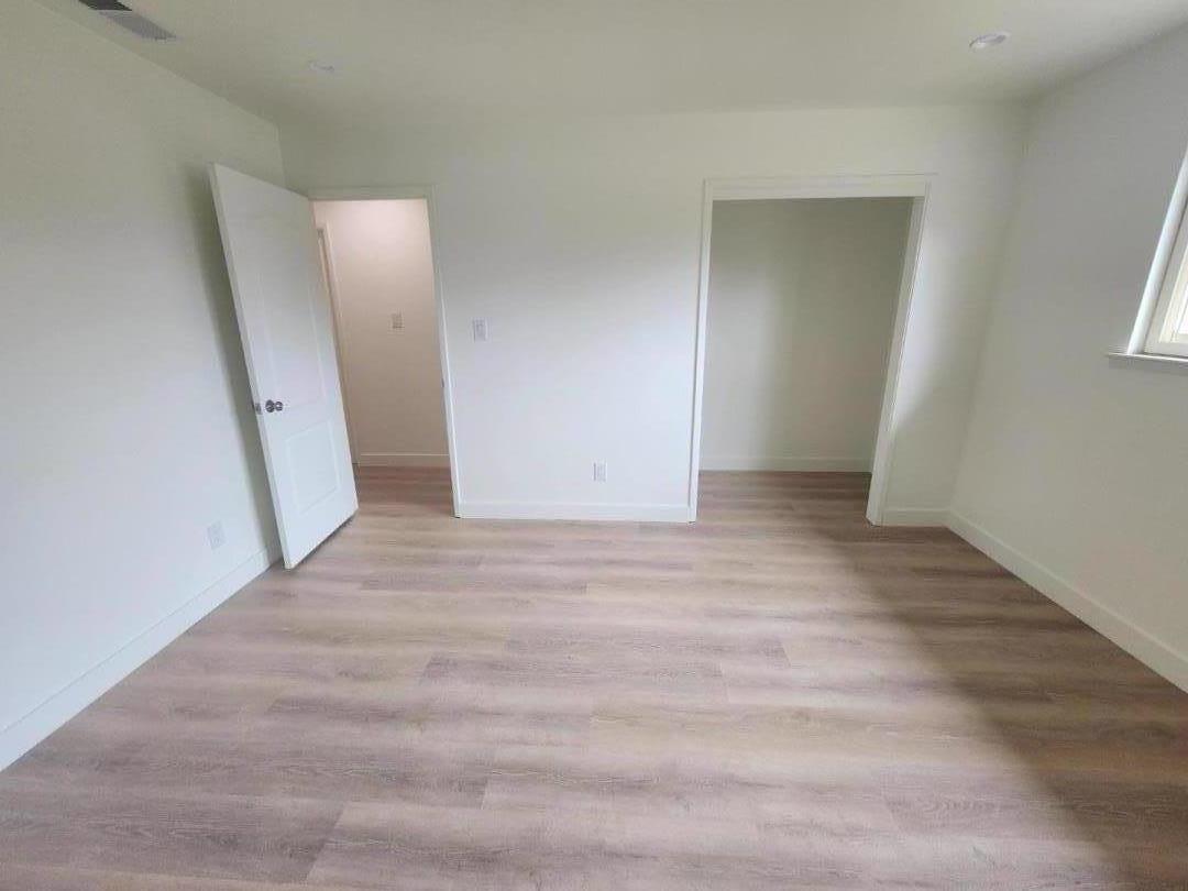 3280 Cheyenne Drive Merced, CA 95348 - Photo 27 of 34 an empty room with wooden floor and mirror