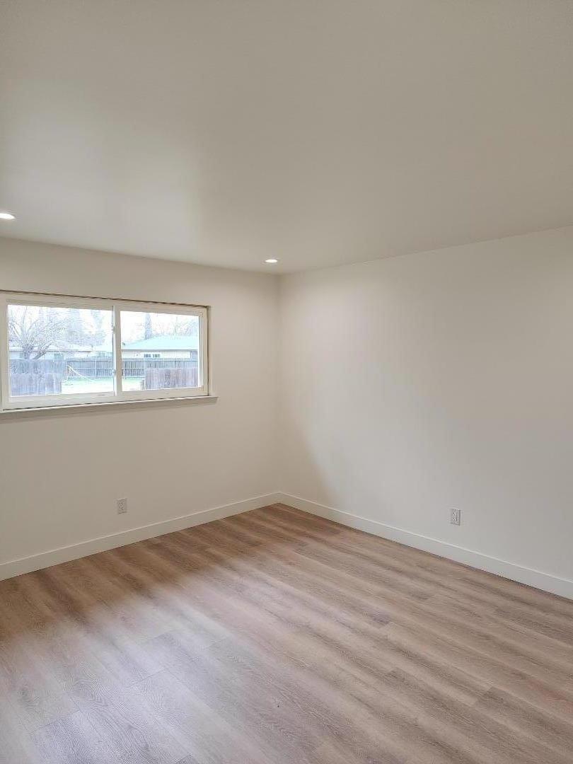 3280 Cheyenne Drive Merced, CA 95348 - Photo 28 of 34 an empty room with wooden floor and windows