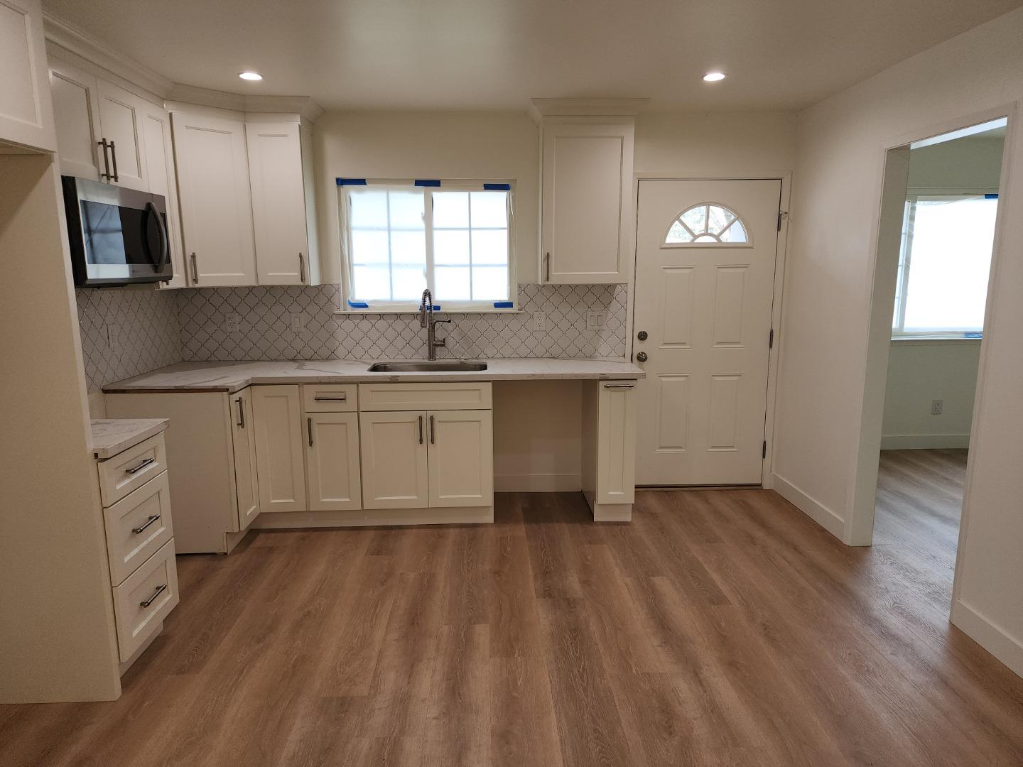 3280 Cheyenne Drive Merced, CA 95348 - Photo 8 of 34 a kitchen with a sink dishwasher a stove and a refrigerator with wooden floor
