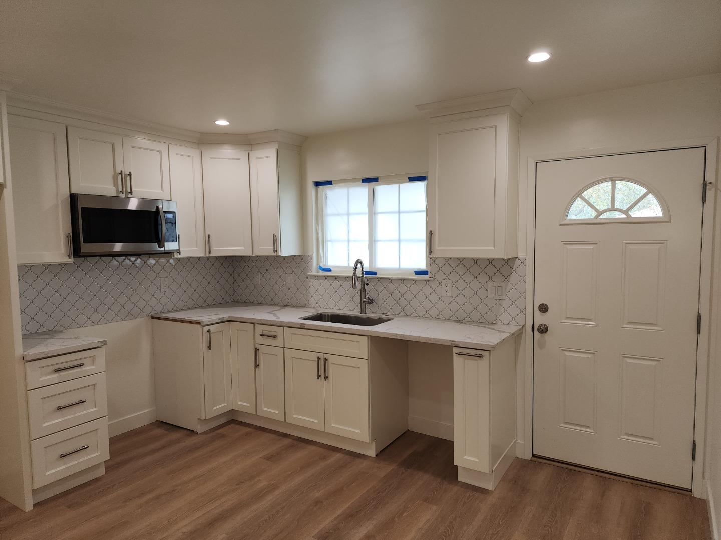 3280 Cheyenne Drive Merced, CA 95348 - Photo 10 of 34 a kitchen with a sink cabinets and wooden floor