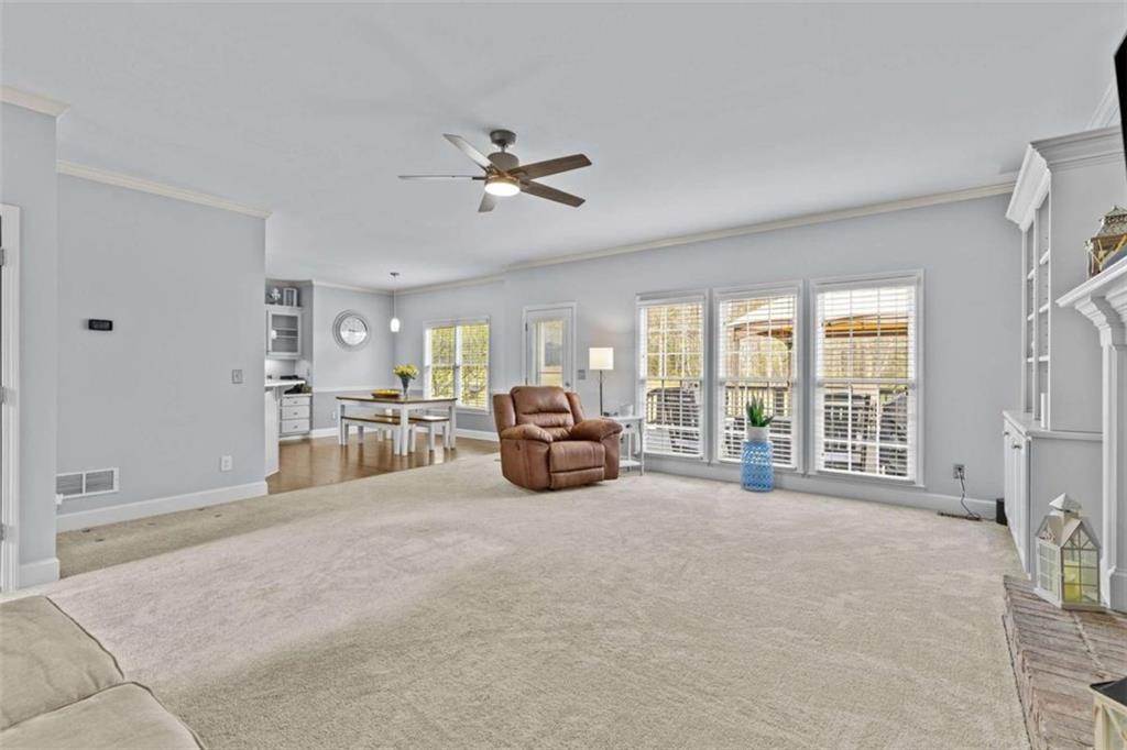 1148 Maple Creek Ridge Loganville, GA 30052 - Photo 12 of 46 a living room with furniture and a large window