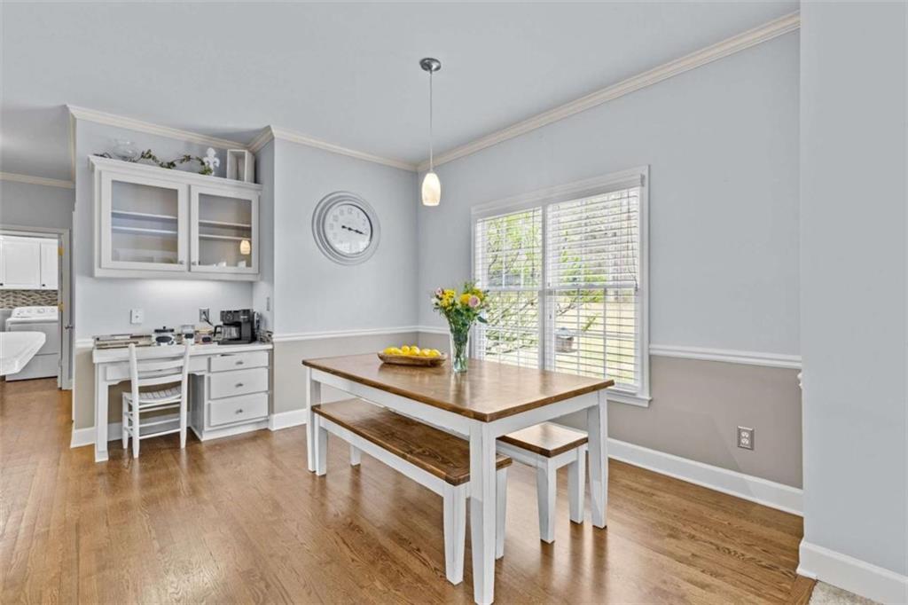 1148 Maple Creek Ridge Loganville, GA 30052 - Photo 13 of 46 a kitchen with a stove and a table chair