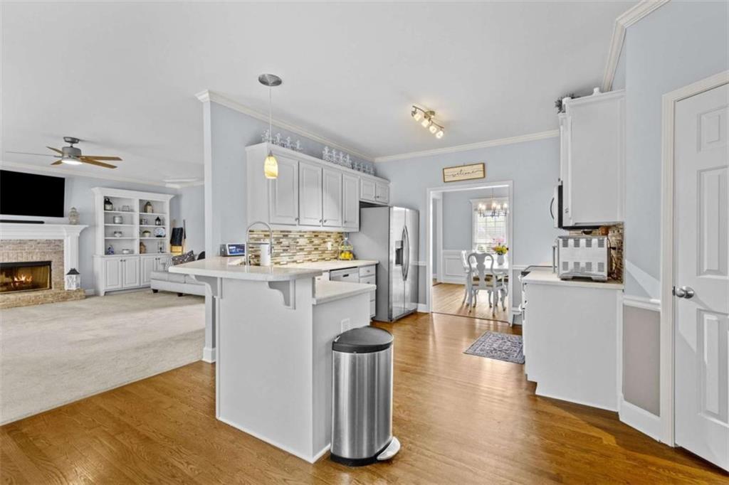 1148 Maple Creek Ridge Loganville, GA 30052 - Photo 15 of 46 a view of kitchen with furniture and wooden floor
