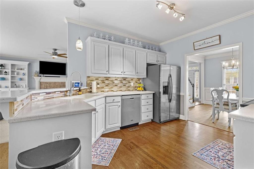 1148 Maple Creek Ridge Loganville, GA 30052 - Photo 16 of 46 a kitchen with kitchen island a sink appliances and cabinets