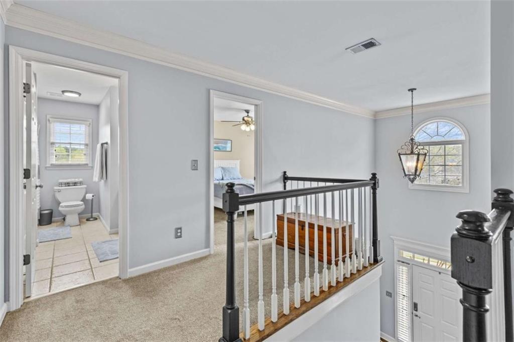 1148 Maple Creek Ridge Loganville, GA 30052 - Photo 21 of 46 a view of a hallway with a livingroom with wooden floor and windows