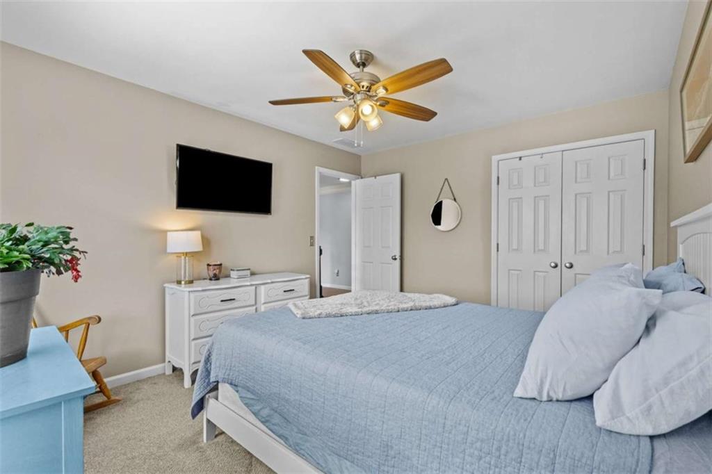 1148 Maple Creek Ridge Loganville, GA 30052 - Photo 23 of 46 a bedroom with a bed and a flat screen tv