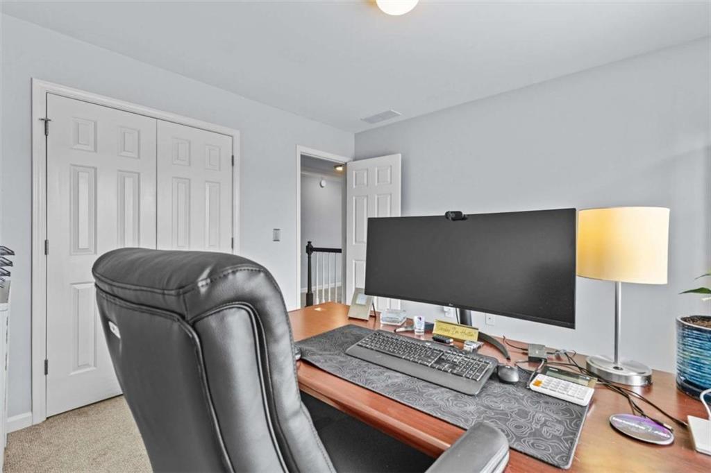 1148 Maple Creek Ridge Loganville, GA 30052 - Photo 26 of 46 a living room with furniture and a flat screen tv