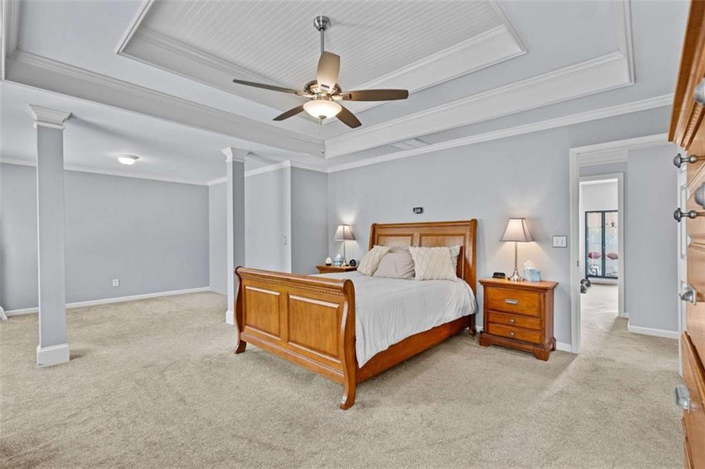 1148 Maple Creek Ridge Loganville, GA 30052 - Photo 28 of 46 a bed room with a bed and a chandelier