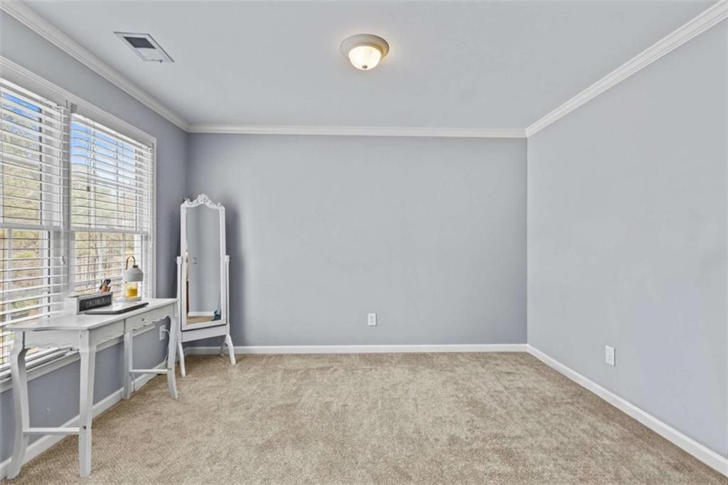 1148 Maple Creek Ridge Loganville, GA 30052 - Photo 30 of 46 a view of an empty room with a window
